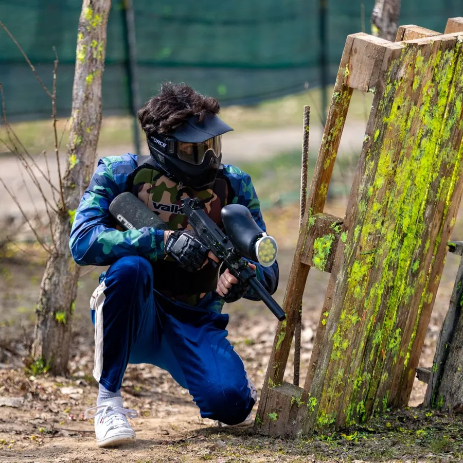A player in camouflage in the woods