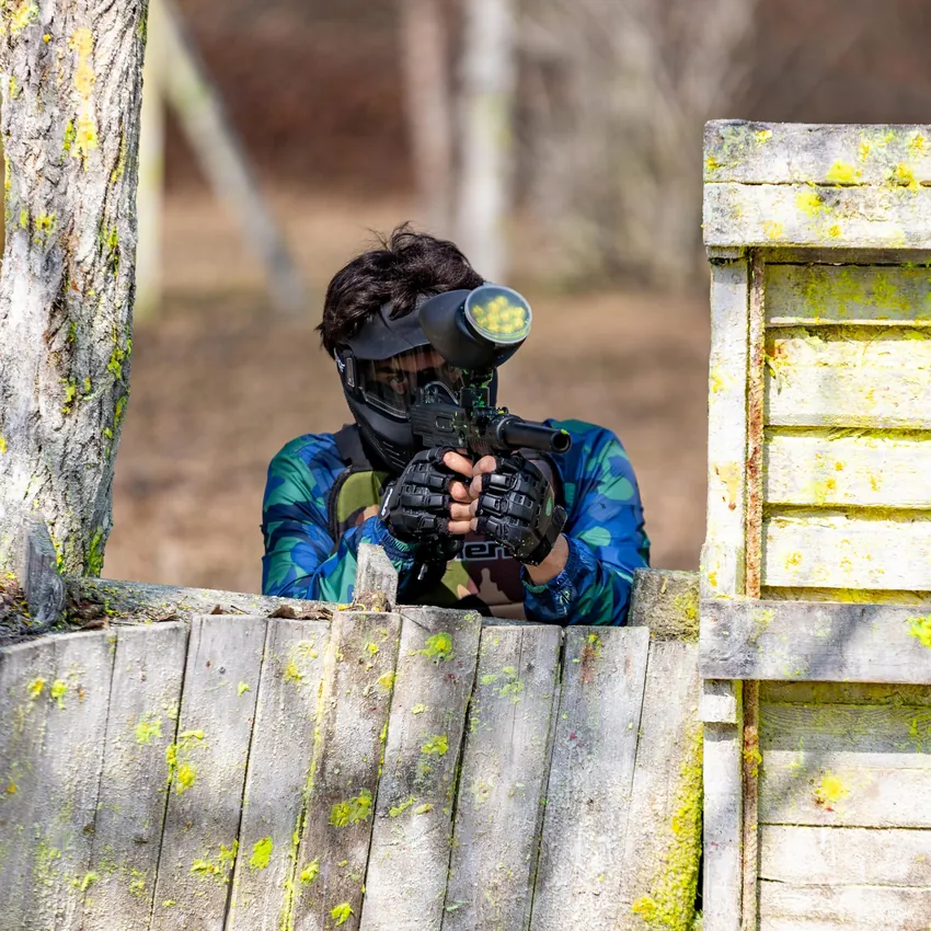 A student lying in wait behind a palisade